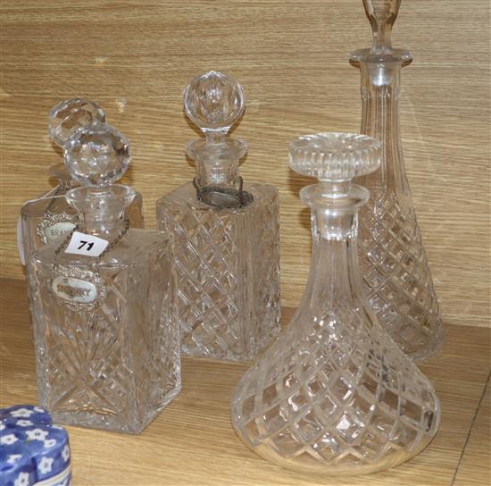 Three cut glass decanters and two others